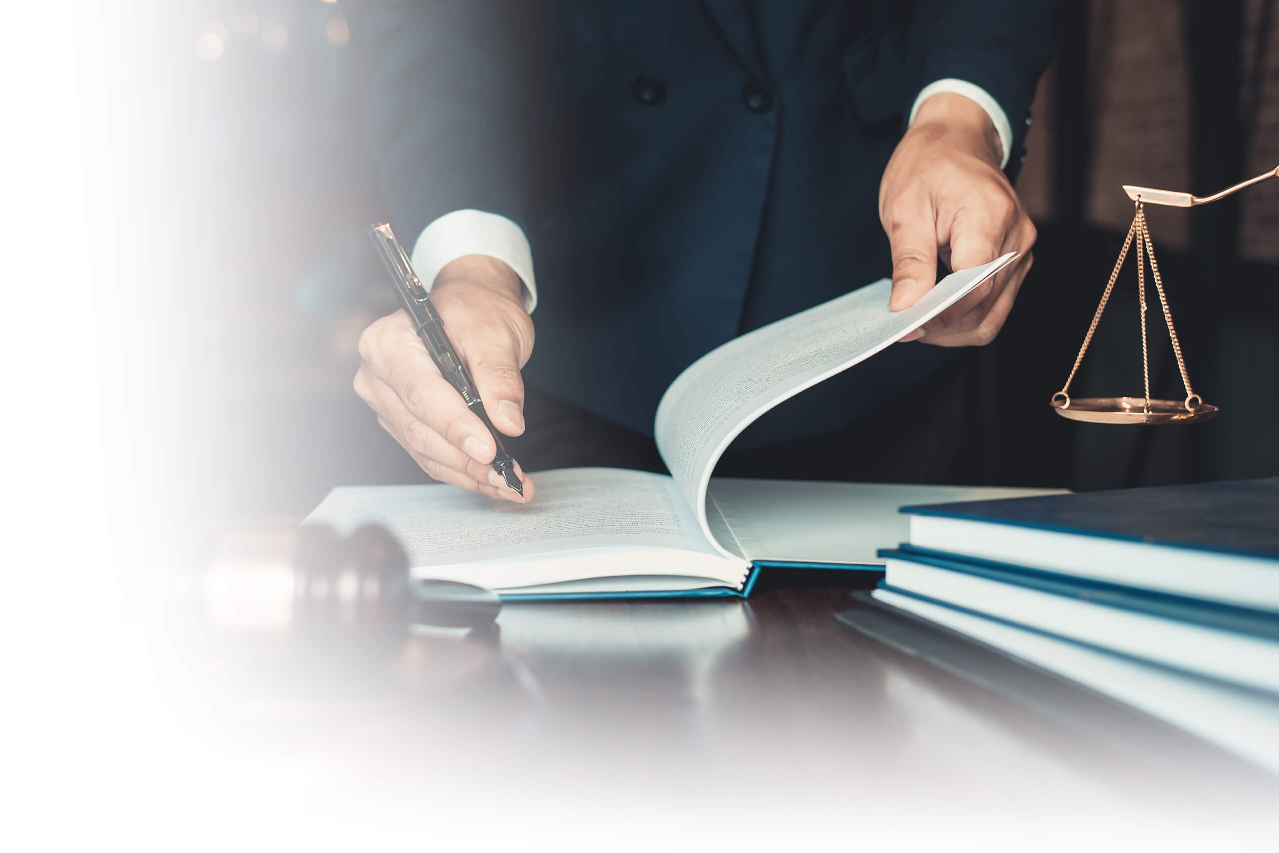 Lawyer examines documents with the Scales of Justice – Career at an international law firm